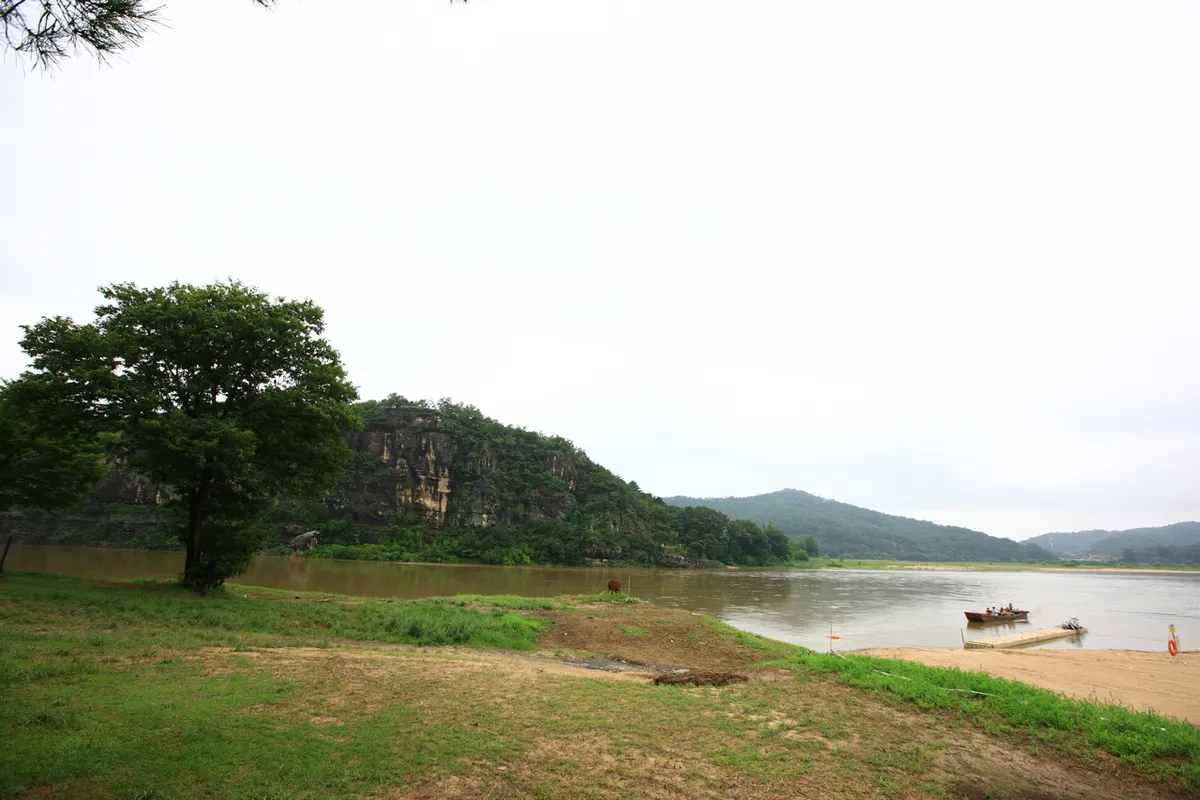 Traditional riverside buildings and trees at Andong Hahoe Village