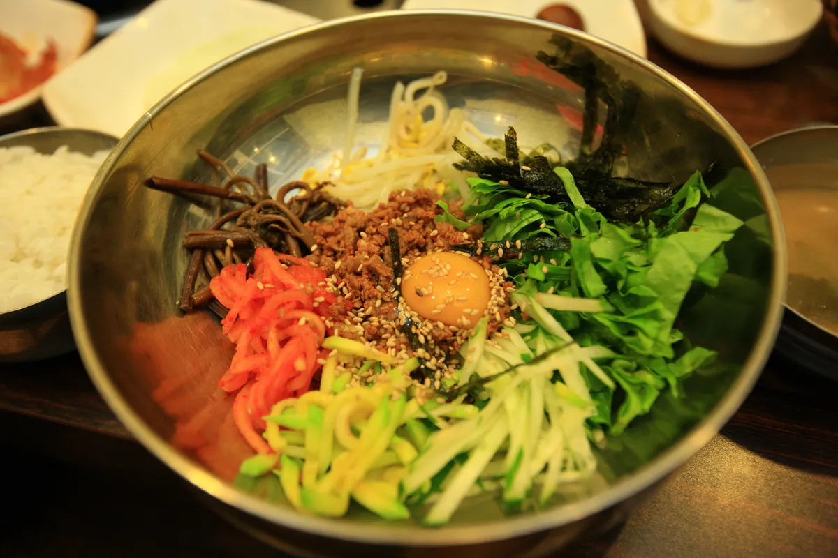 Bibimbap bowl with vegetables and red chili paste for dolsot bibimbap guide