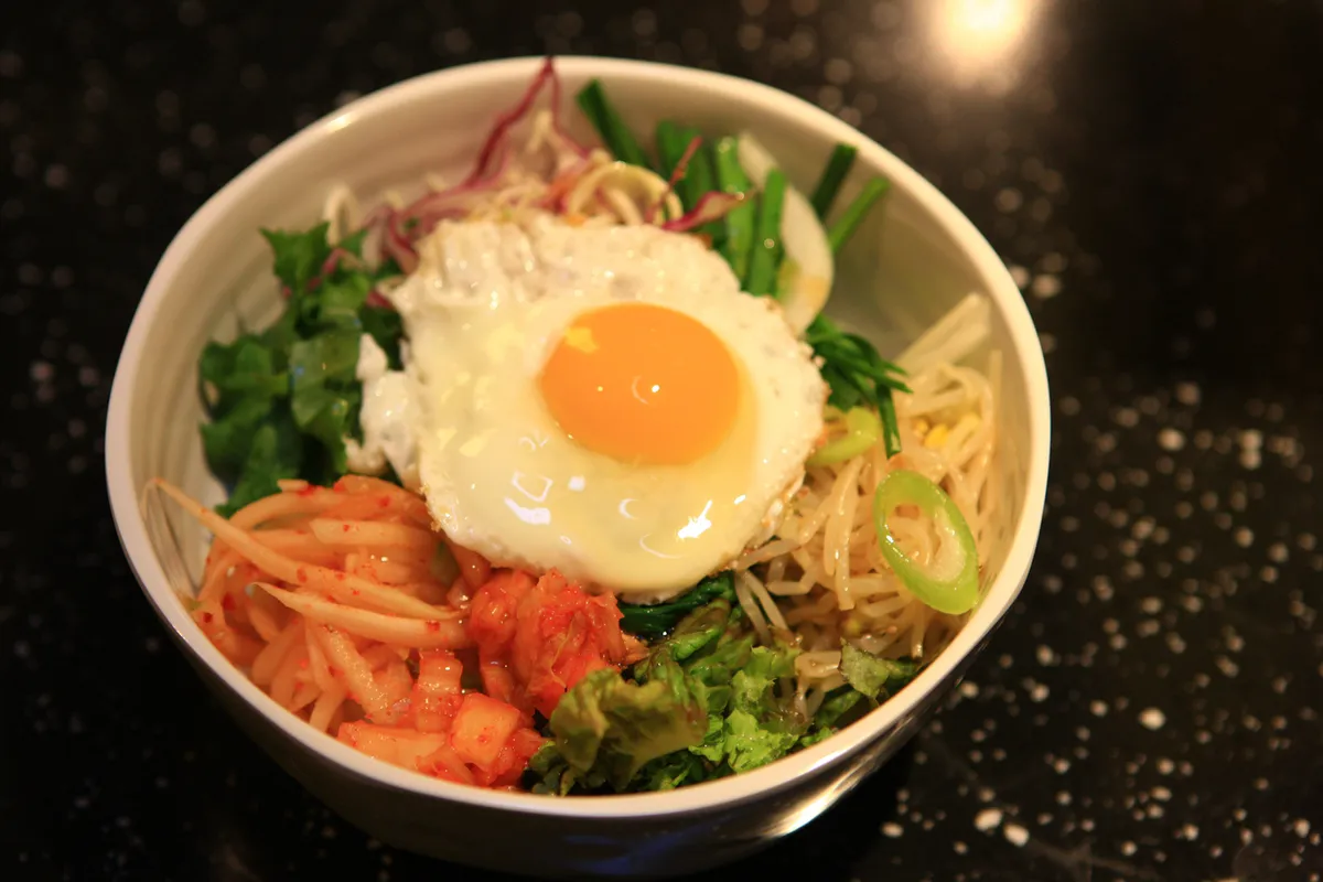 Bibimbap ingredients arranged over rice for Jeonju bibimbap guide