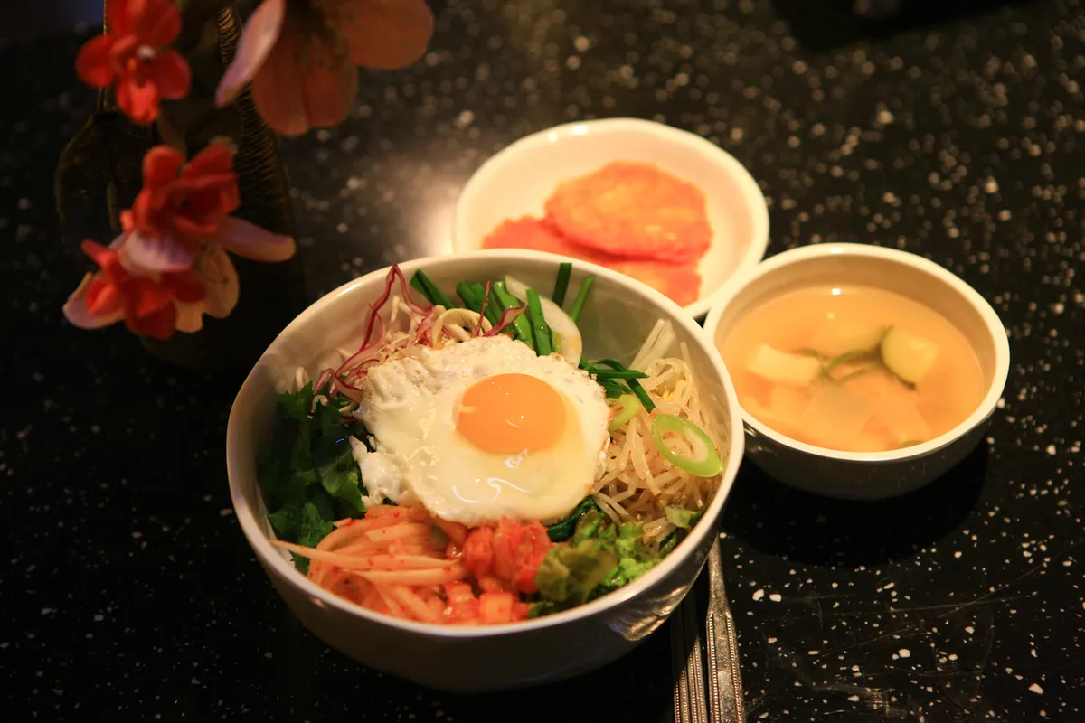 Mixed bibimbap bowl with rice vegetables and gochujang for Korean food guide