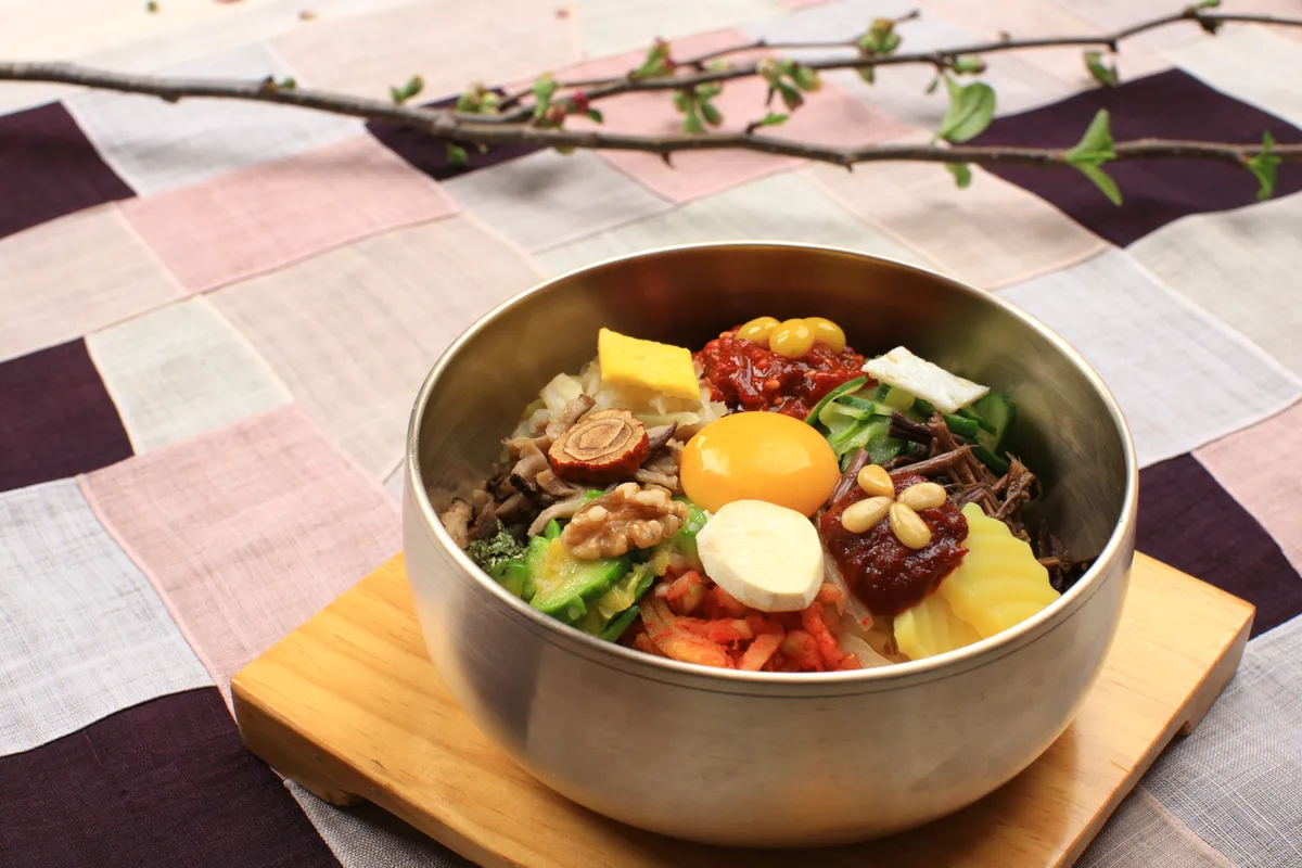 Bibimbap served in a Korean restaurant bowl for Jeonju style bibimbap guide