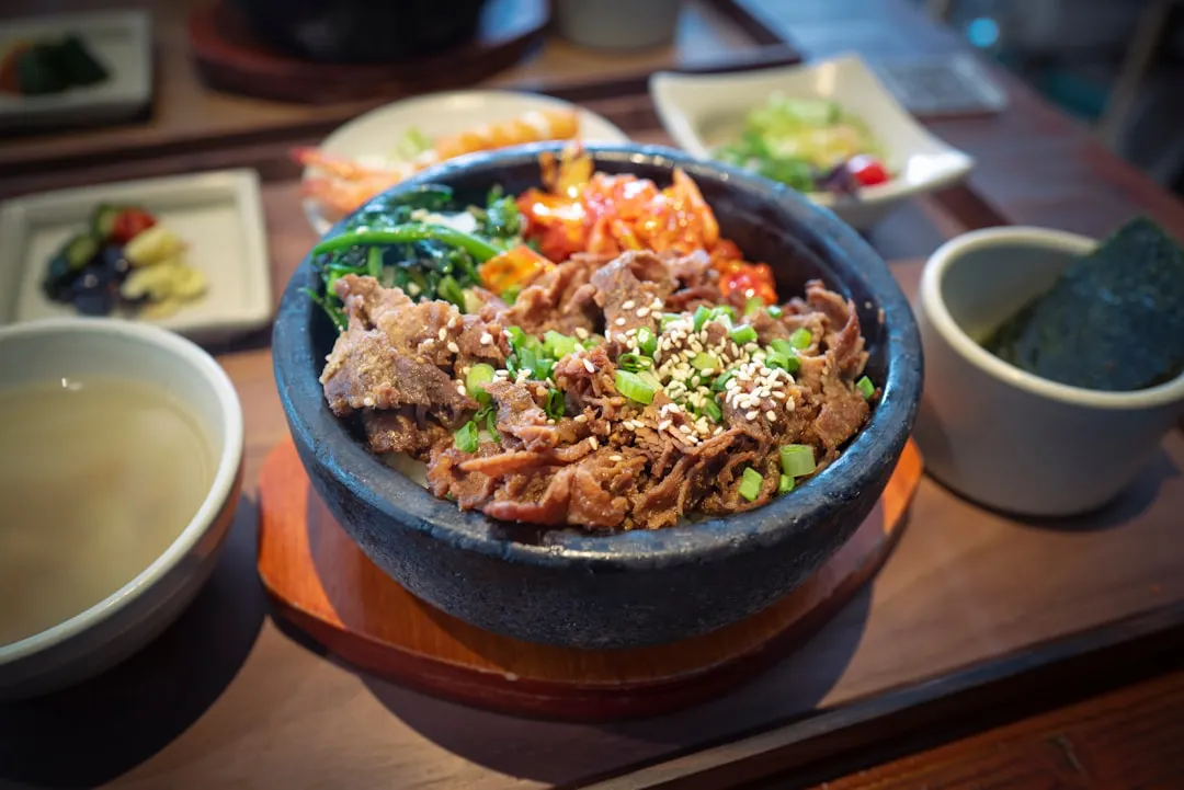 Bulgogi rice bowl served with soup and side dishes