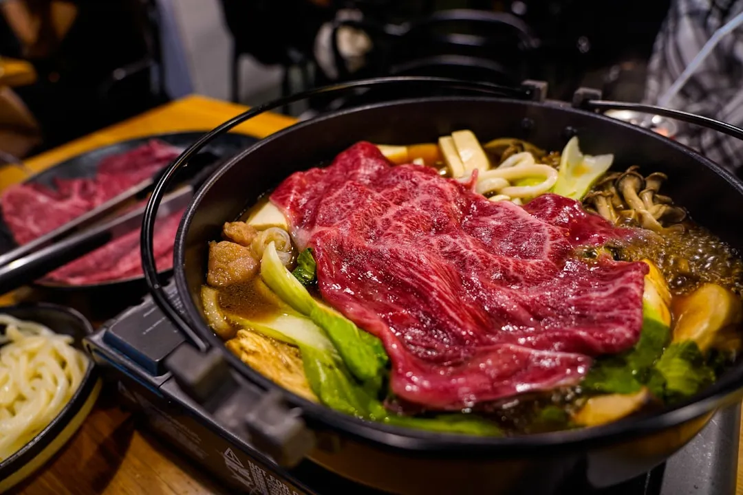 Raw beef and vegetables cooking in a bulgogi-style hot pot