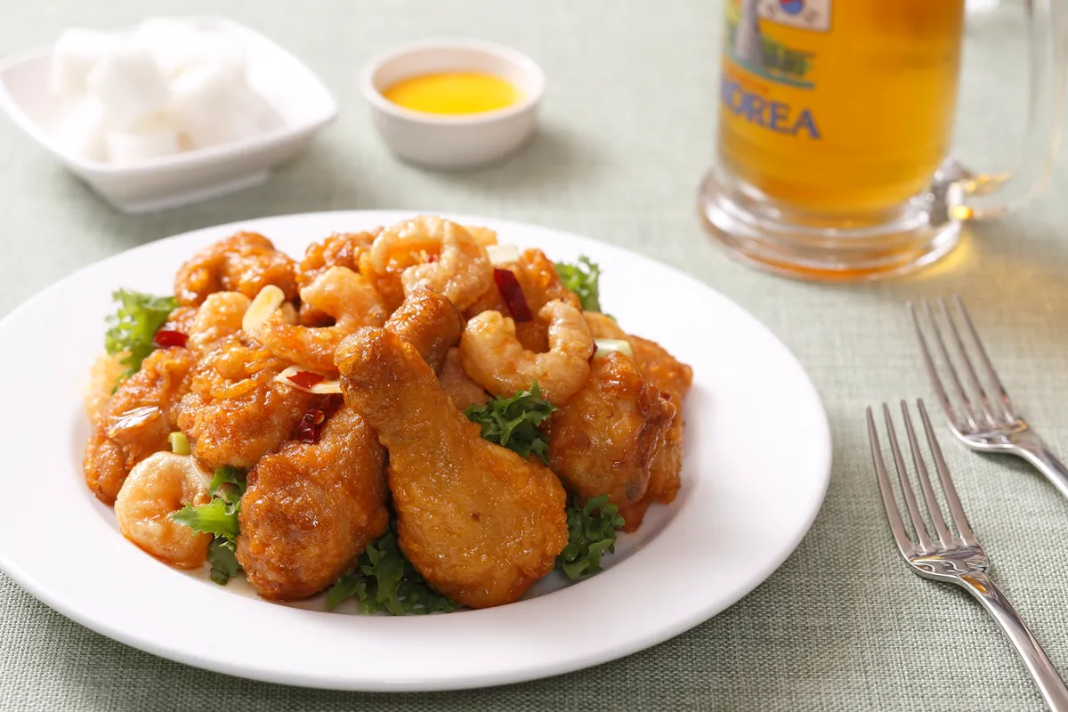 Korean chicken pieces served with beer and pickled radish for chimaek