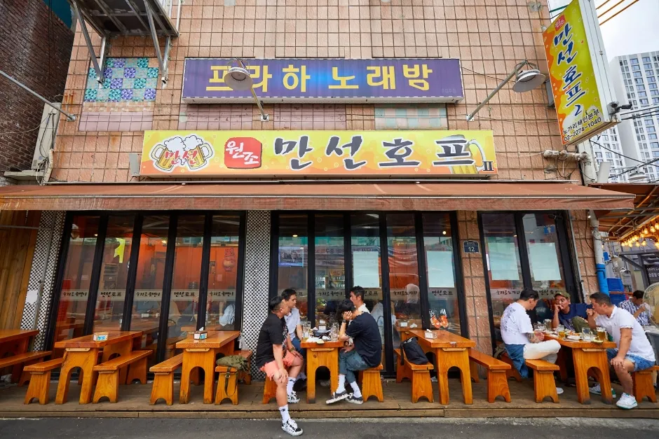 Outdoor tables and Korean pub signs in Euljiro Nogari Alley