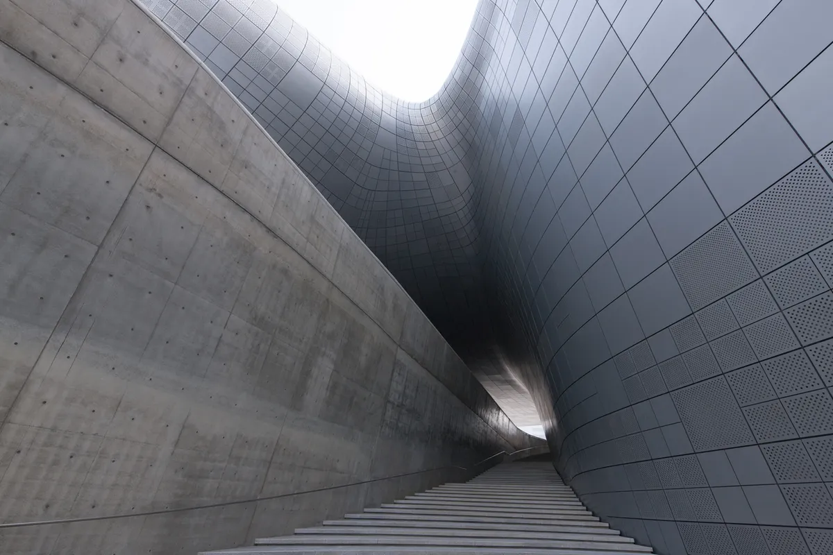 Curved metal walls and stairs at Dongdaemun Design Plaza near the hotel district