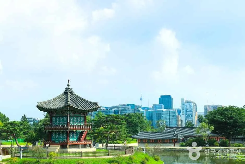 Hyangwonjeong Pavilion with Seoul skyline behind Gyeongbokgung Palace