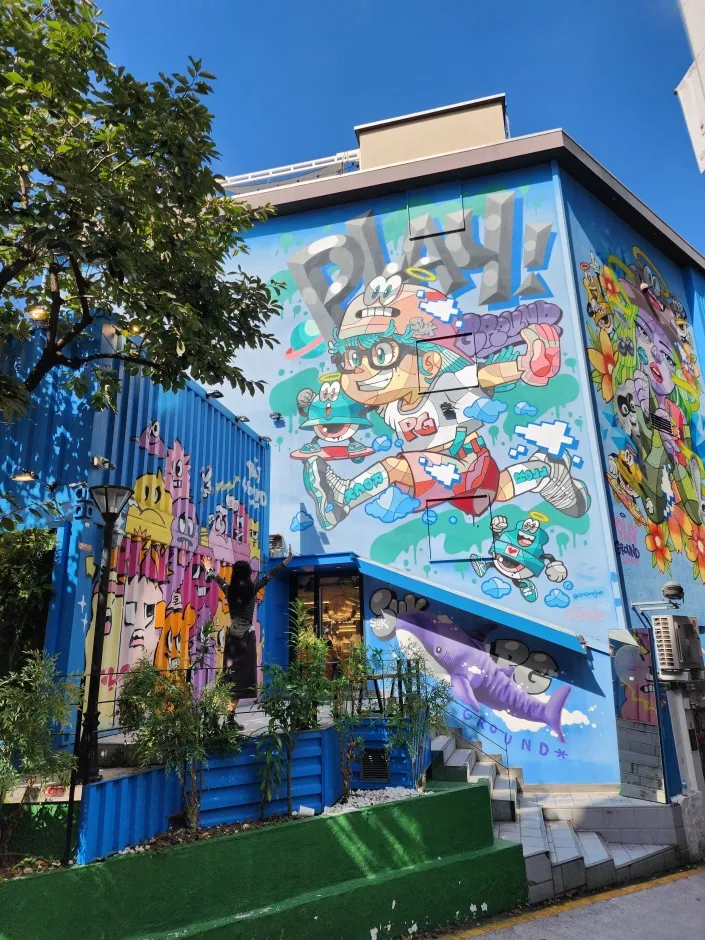 M Playground Hongdae Branch exterior with blue container-style facade for Hongdae fashion shopping