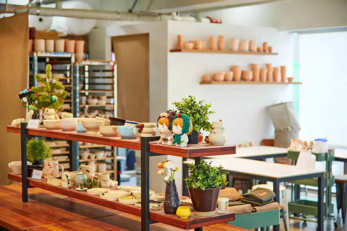 Ceramic Cafe JOOL interior with pottery shelves for Hongdae craft shopping route