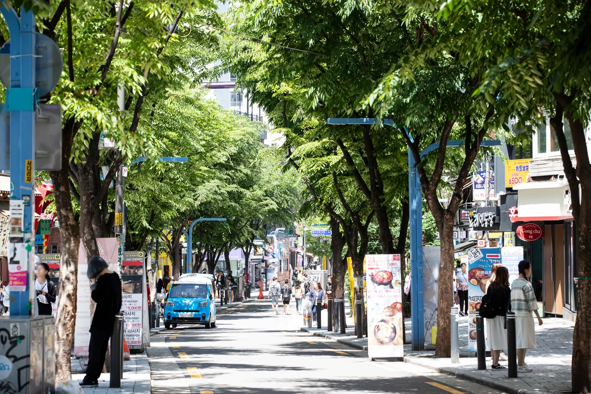 Hongdae street shops and signs near Hongik University Station for tax refund route checks