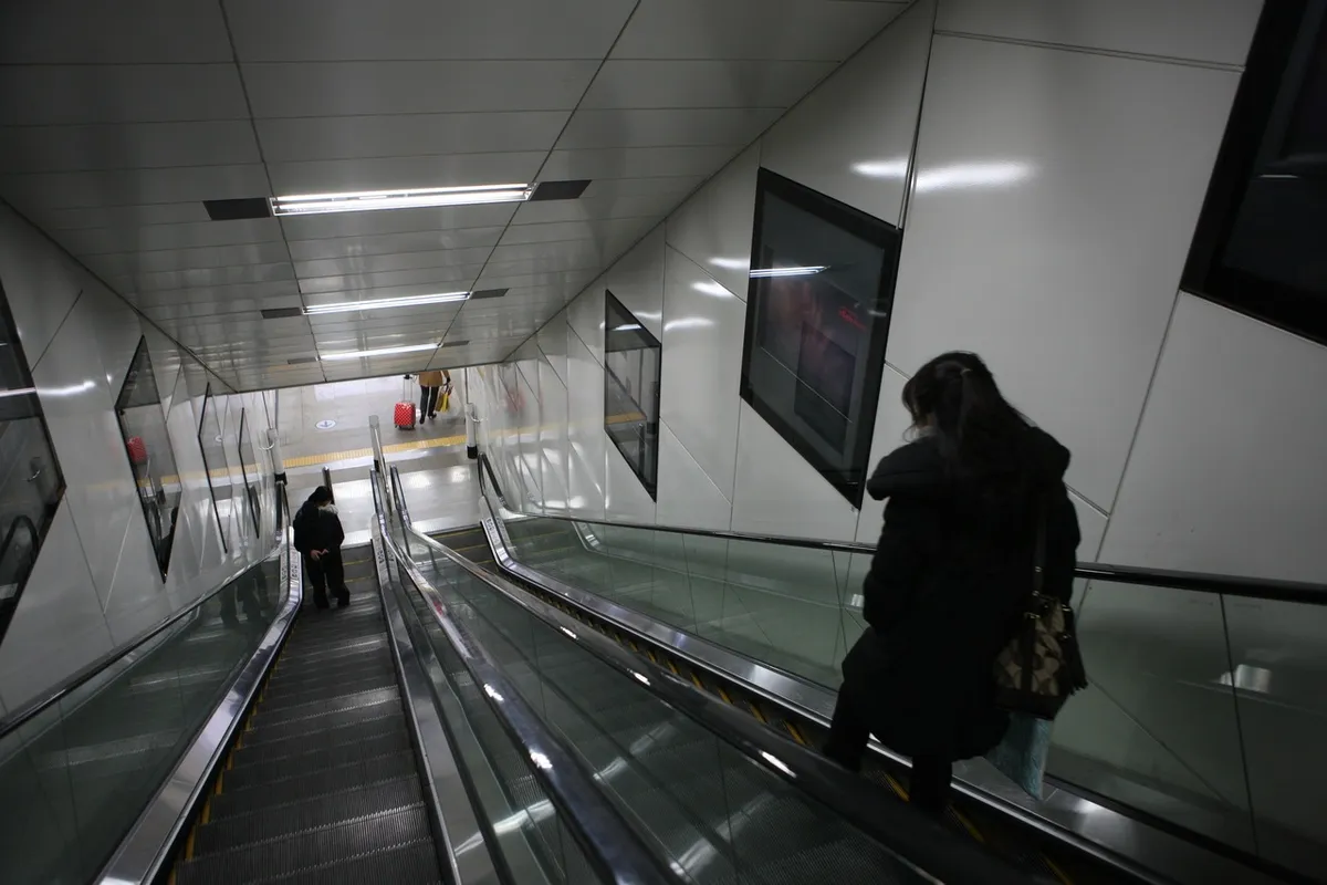 Passengers on escalators inside Yangjae subway station in Seoul.