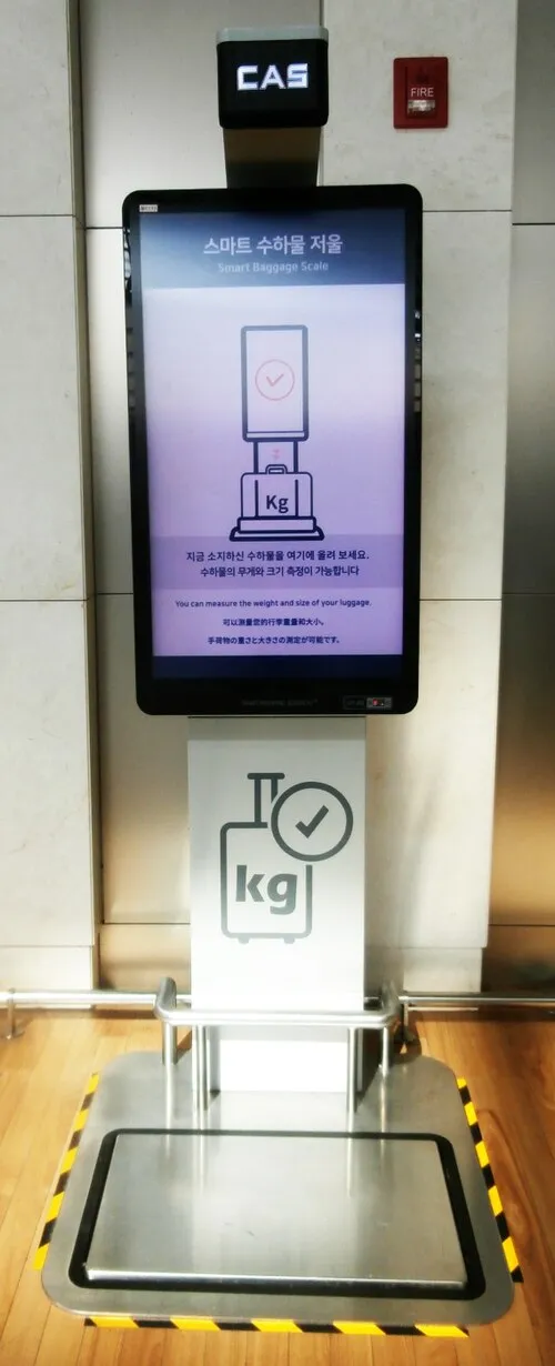 Smart baggage scale at Incheon Airport with Korean and English instructions and an empty weighing platform