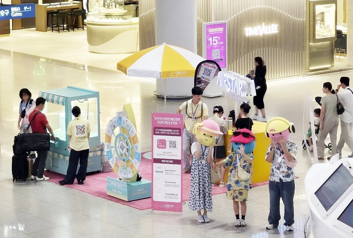 Travelers at an Airstar Duty Free information booth inside Incheon Airport