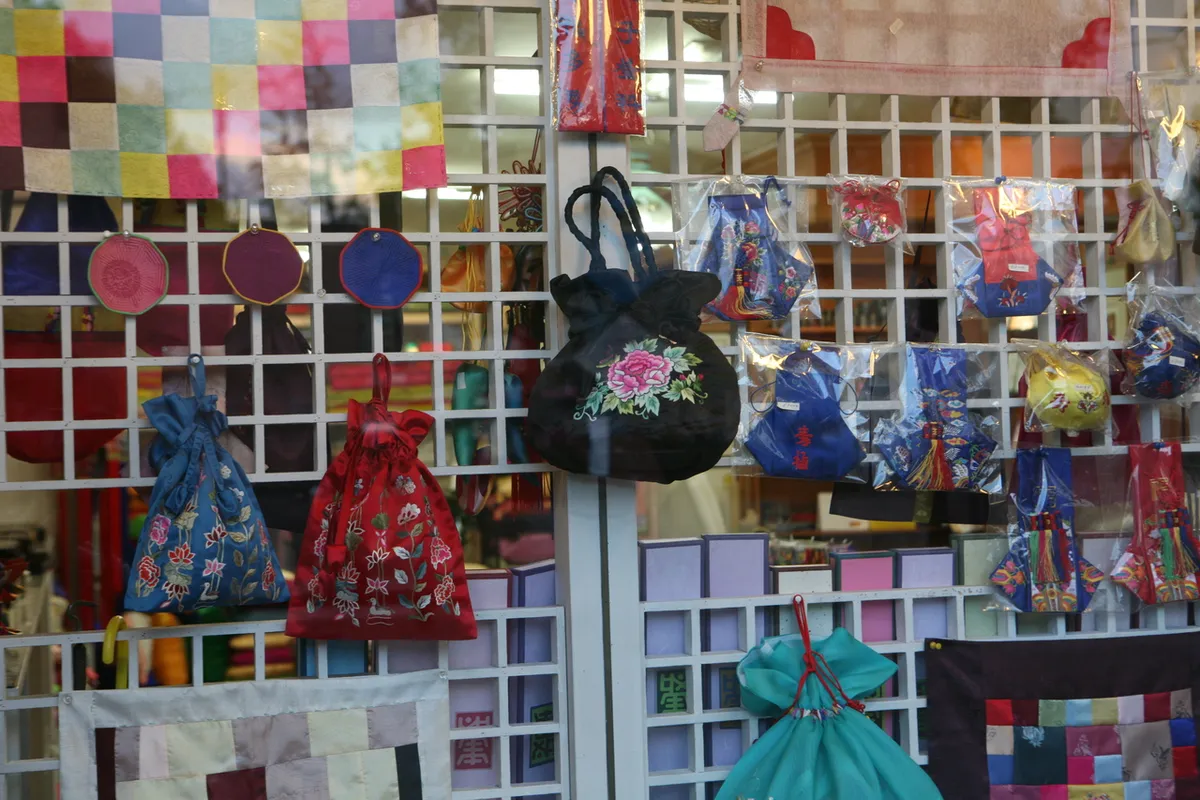 Colorful craft bags displayed in an Insadong souvenir shop for traditional Korean gifts