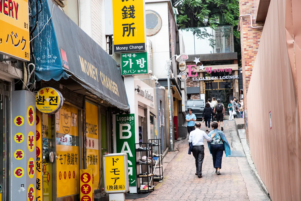 Multilingual shop signs and pedestrian alley in Itaewon Seoul