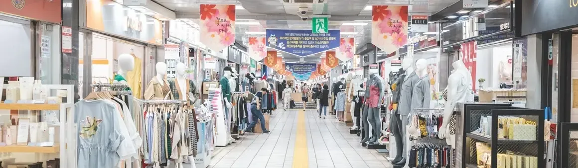 Main retail corridor with clothing displays inside Jeju Jungang Underground Shopping Center