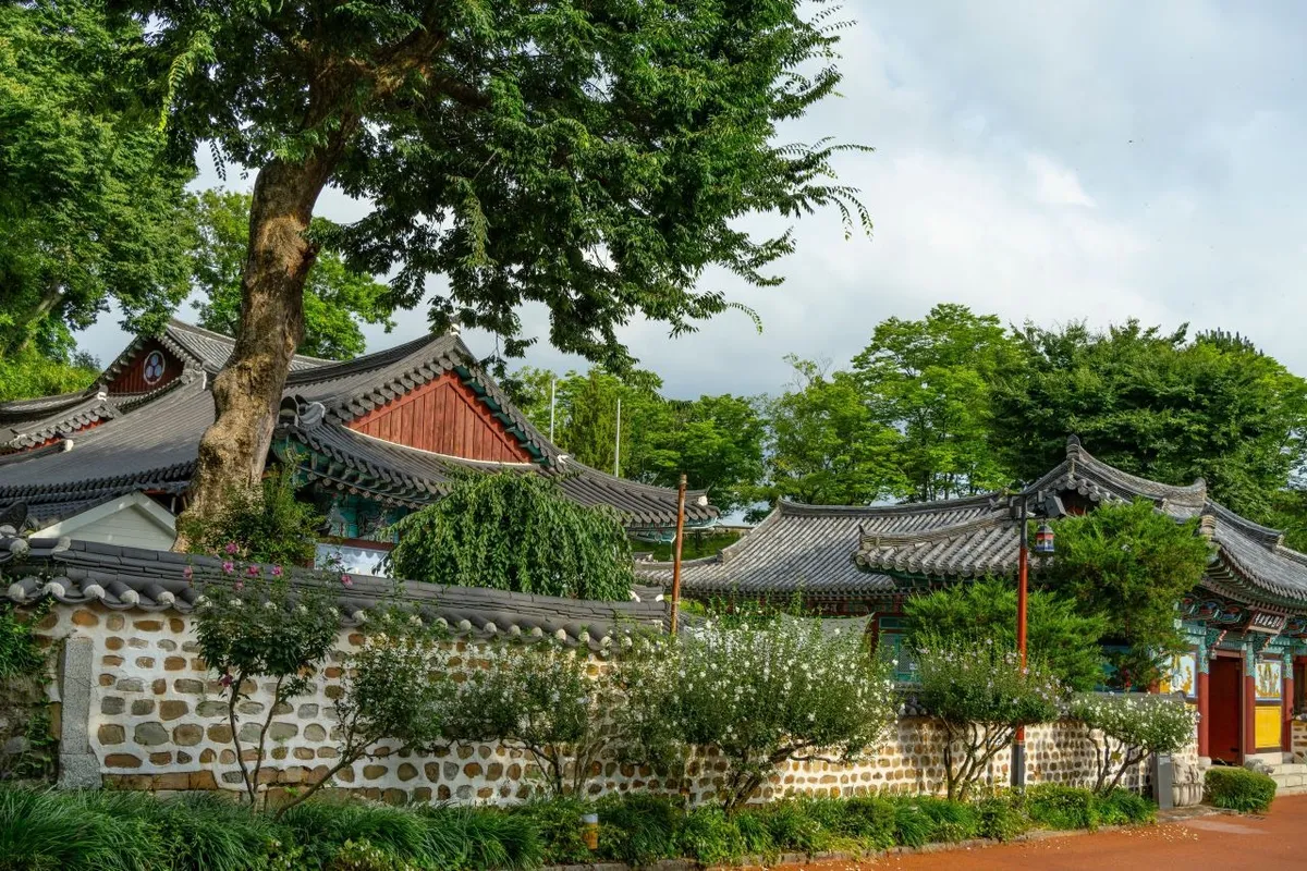 Stone wall and traditional tiled-roof buildings inside Jinjuseong Fortress