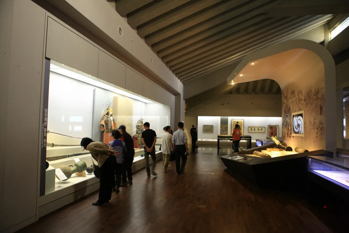 Visitors viewing illuminated displays inside Jinju National Museum