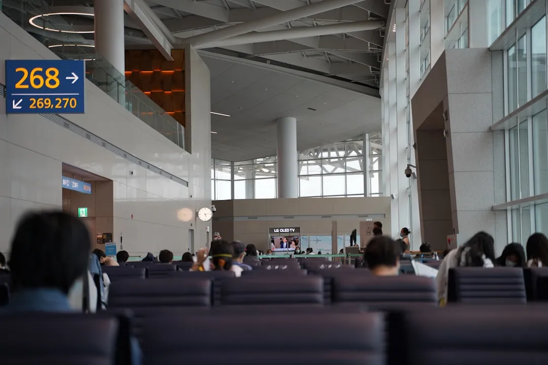 Passengers seated inside an airport terminal for K-ETA application guide