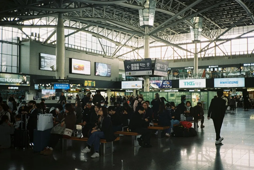 Travelers waiting in an airport terminal for K-ETA application guide