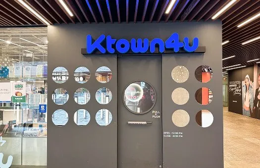Ktown4u K-pop album shop entrance with blue signage and glass merchandise displays in Insadong