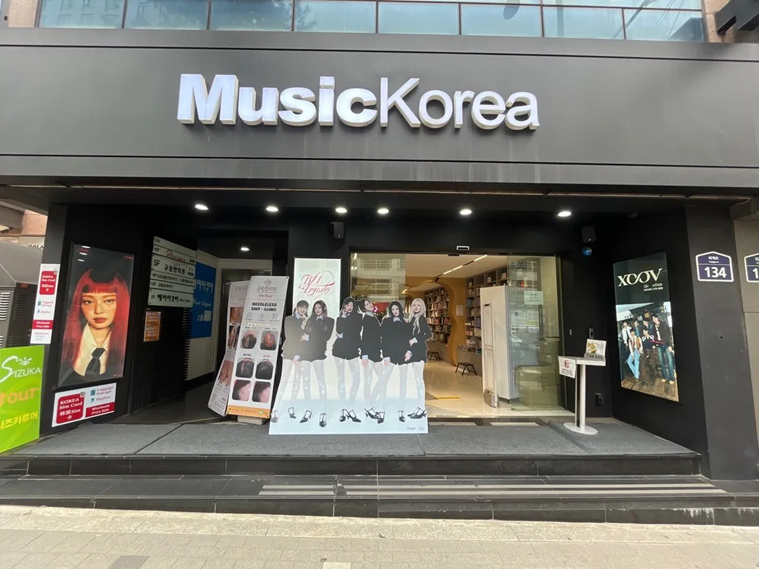 Street-level Music Korea K-pop album shop entrance with artist posters at 134 Toegye-ro in Myeongdong