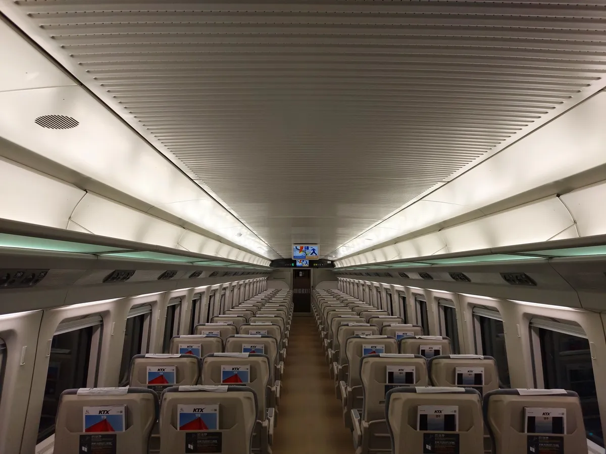 KTX-Cheongnyong standard-class seats and central aisle in a KORAIL Pass seat-reservation guide.