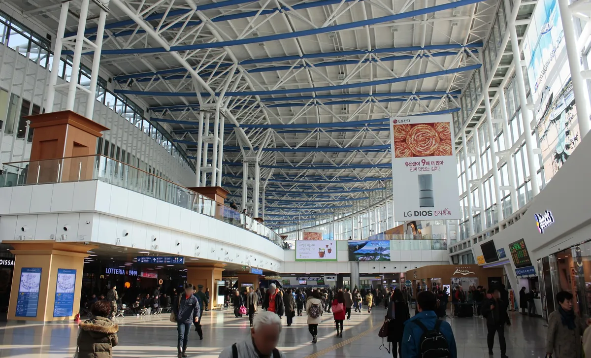 Passengers in the Seoul Station railway concourse for KORAIL Pass travel.