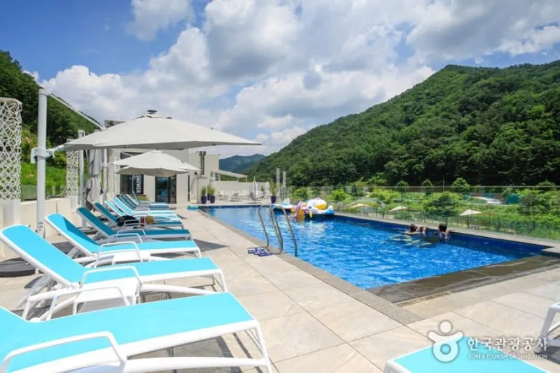 Outdoor pool and loungers in a pension photograph published by VISITKOREA
