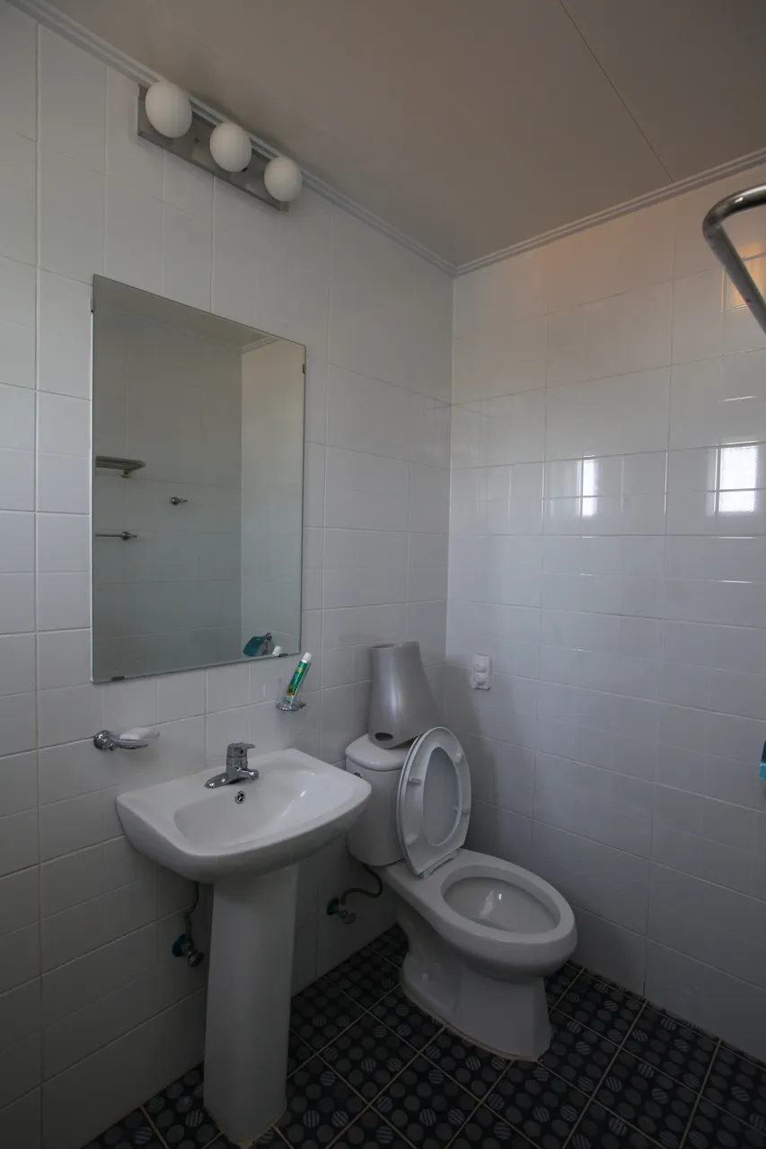 Compact bathroom with washbasin, mirror and toilet at Guesthouse Jip, an illustrative facility photograph