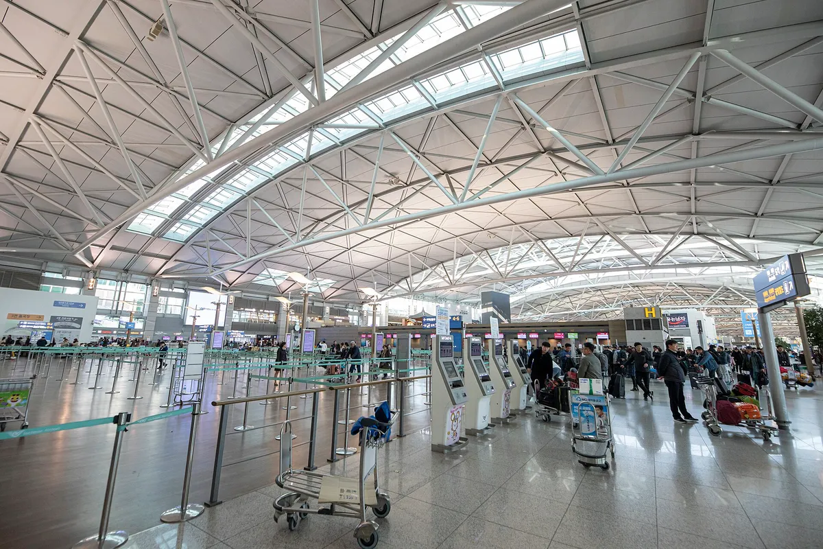 Incheon Airport Terminal 1 departure hall with passengers and luggage