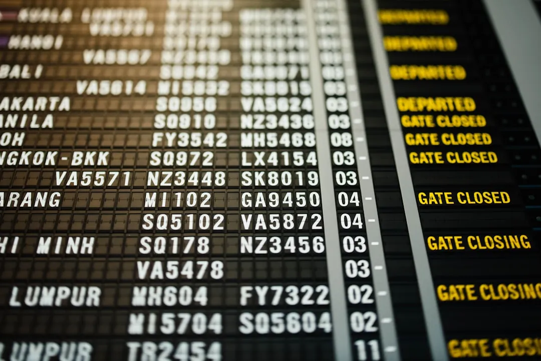 Airport departure board used to check domestic flight gate and time