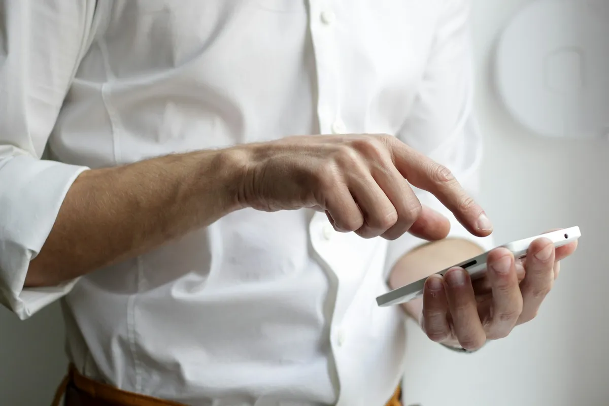 Person entering travel information on a smartphone