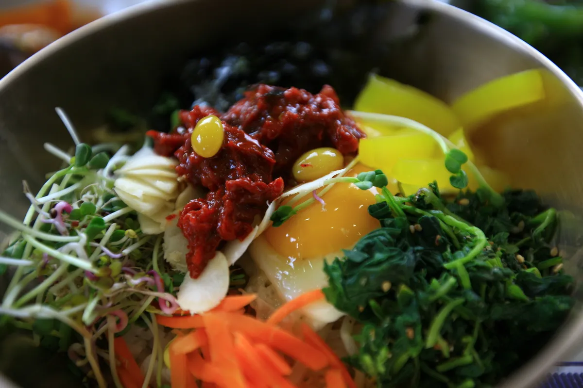 Bibimbap bowl with vegetables and rice for Korea restaurant etiquette