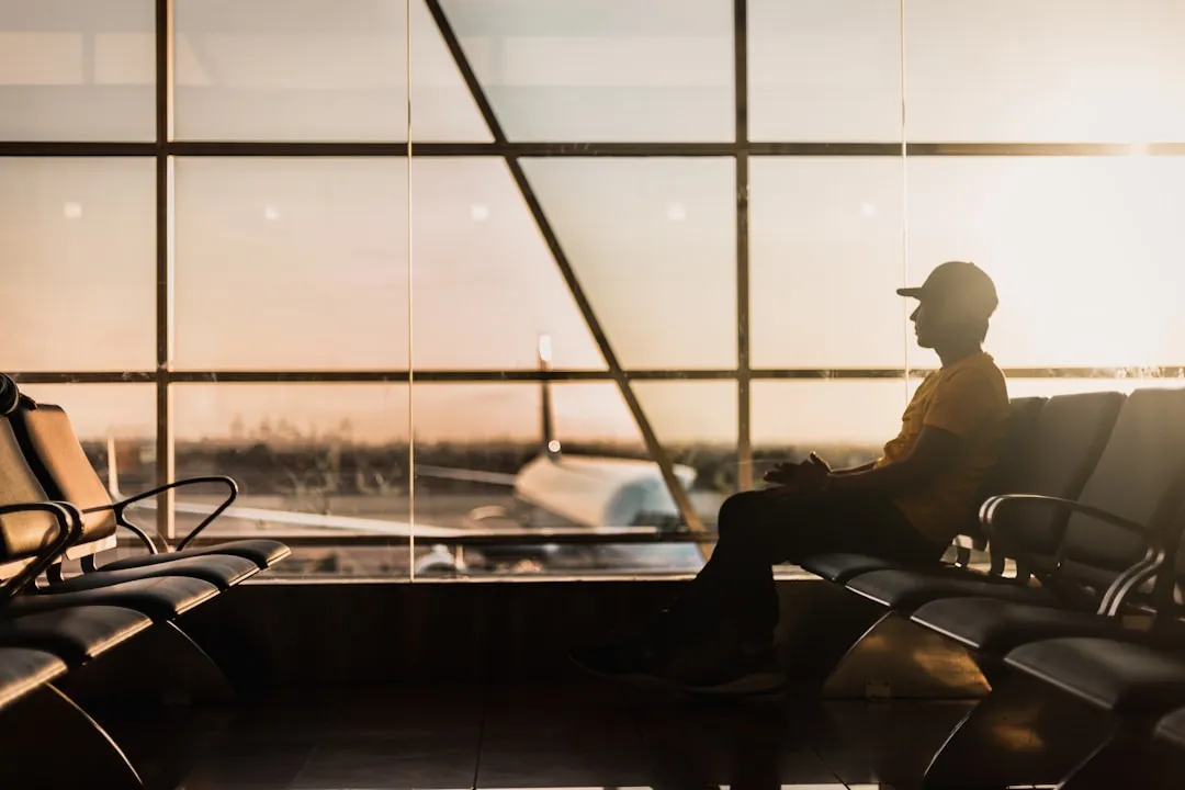 Traveler using a smartphone in an airport for Korea SIM card vs eSIM setup