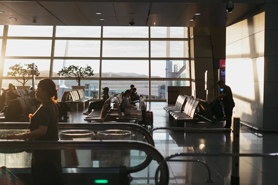 Traveler waiting at an airport with phone for Korea SIM card pickup planning