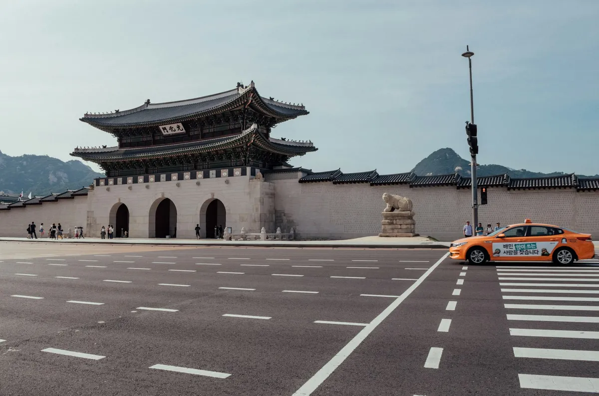 Orange taxi on a Korean street for taxi travel in Korea