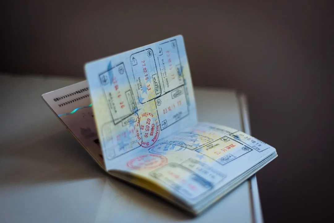 Open passport with entry stamps for a Korean visitor visa application