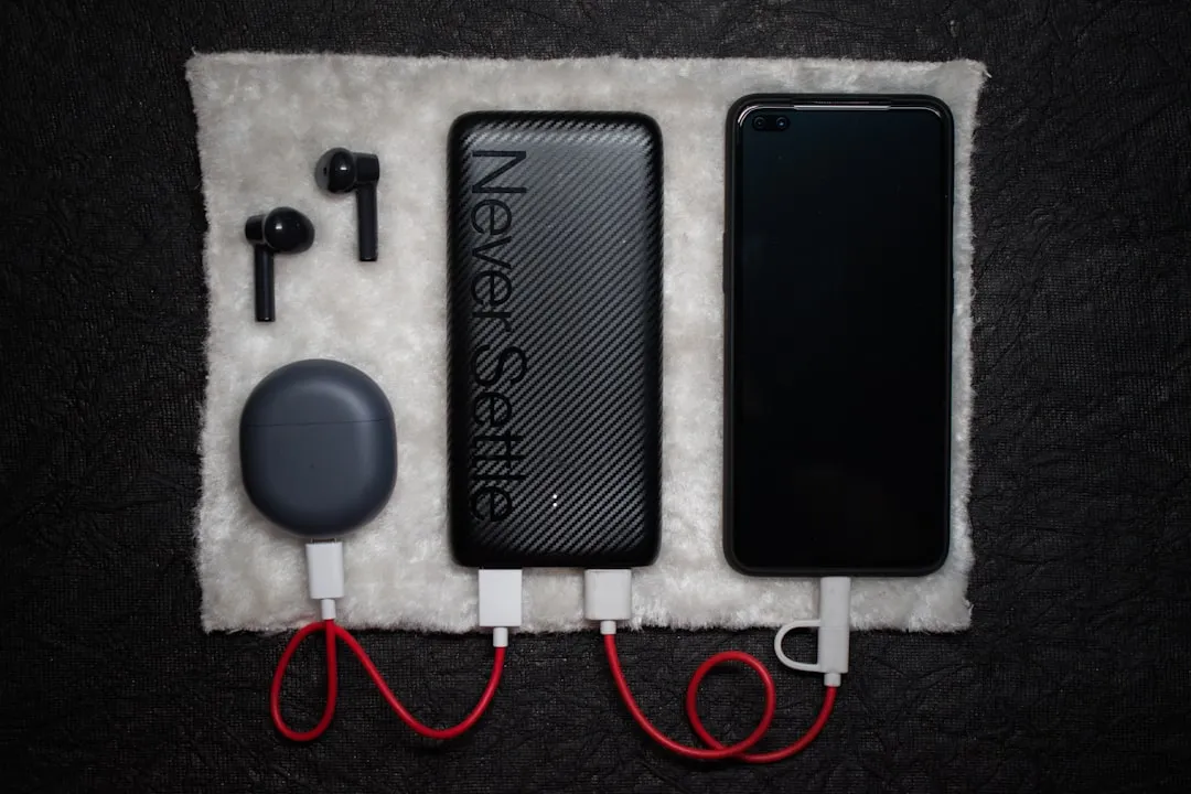 Phone beside USB charging cable for Korea travel adapter packing