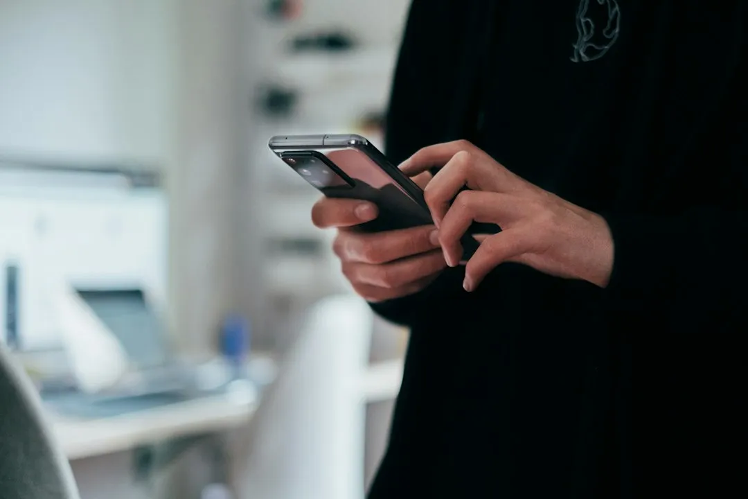 Hands using a smartphone indoors for predeparture Korea travel apps preparation
