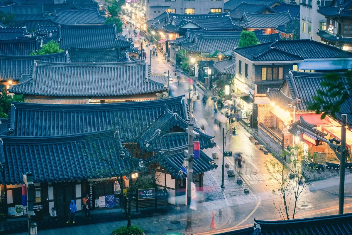 Wet tiled roofs and streets at Jeonju Hanok Village during rainy weather in Korea
