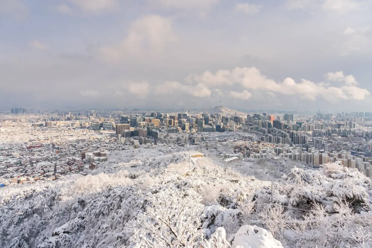 Snow-covered Seoul cityscape and Namsan during heavy winter weather