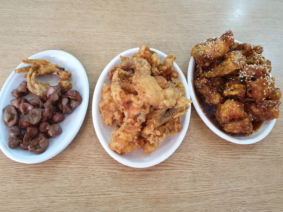 Plates of fried and sauce-coated chicken in Suwon, illustrating baseball food chicken options