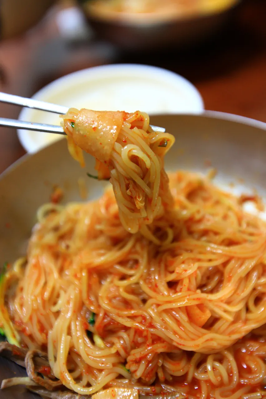 Bibim milmyeon noodles mixed with red sauce for a cold noodle guide