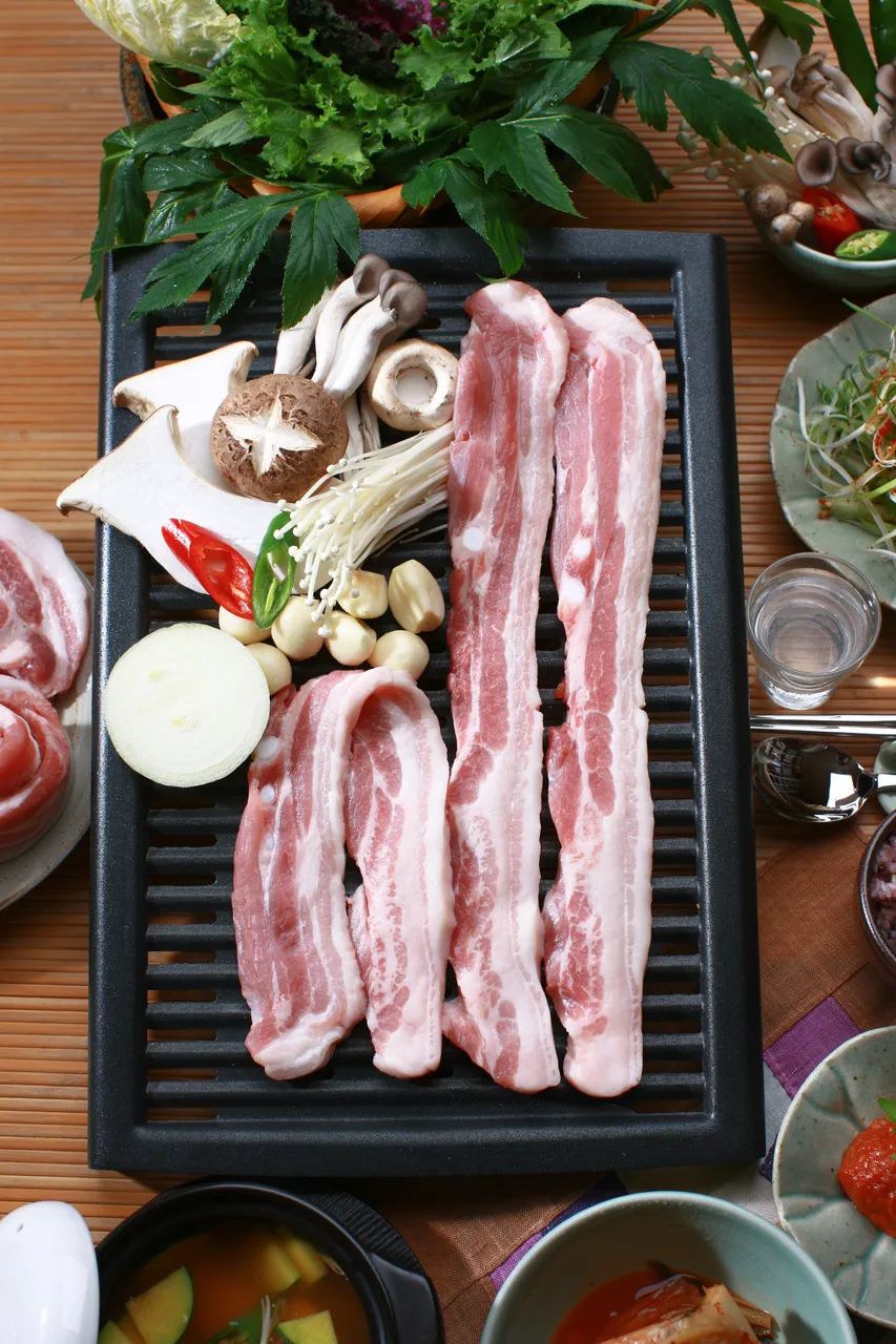 Samgyeopsal pork belly grilling at a Korean barbecue table