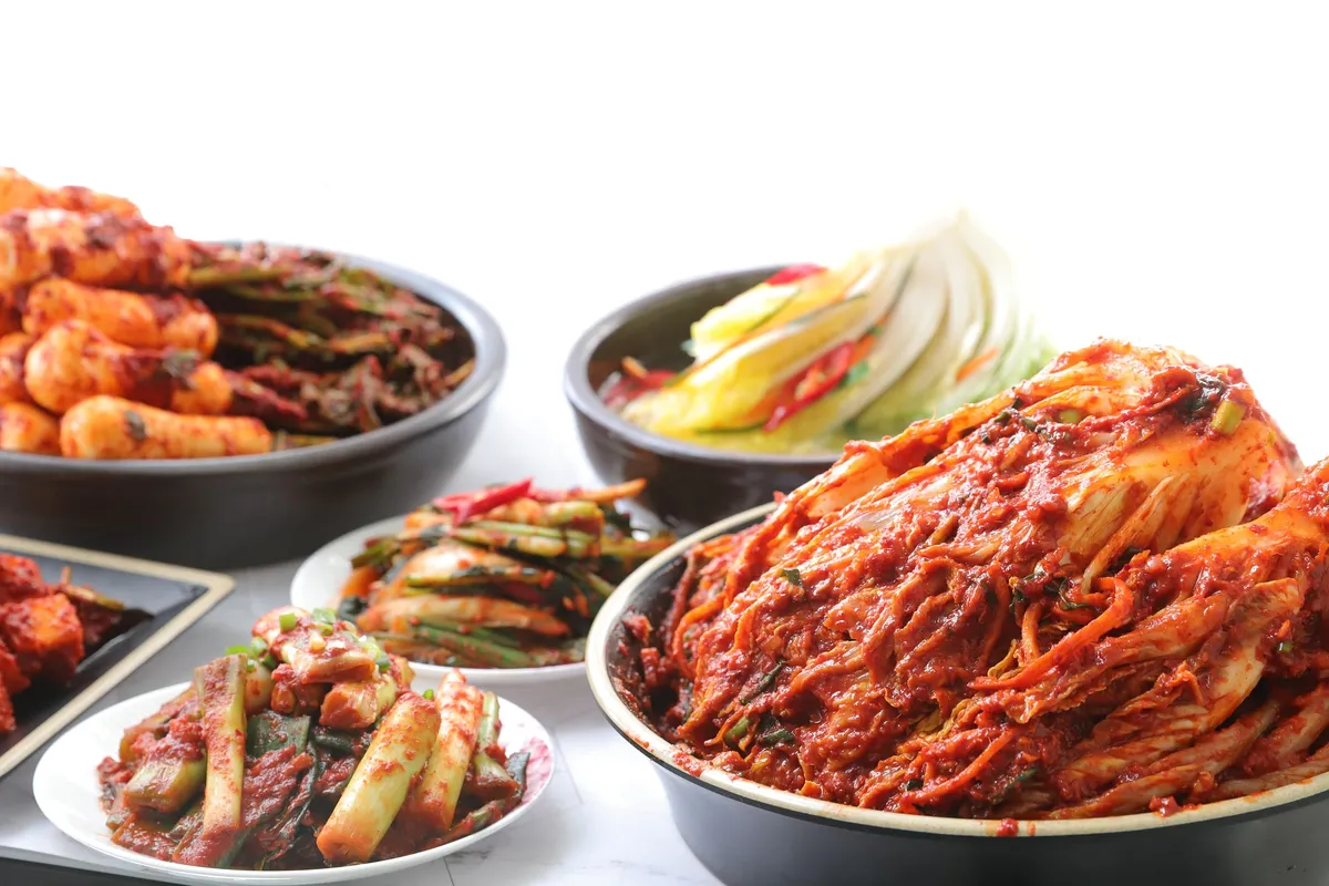 Kimchi preparation with cabbage and red seasoning for Korean food beginners