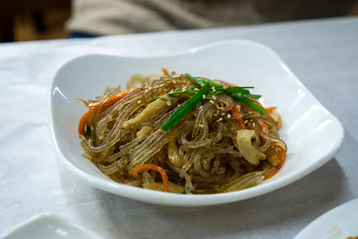Japchae clear noodles with vegetables in a Korean food beginner's guide
