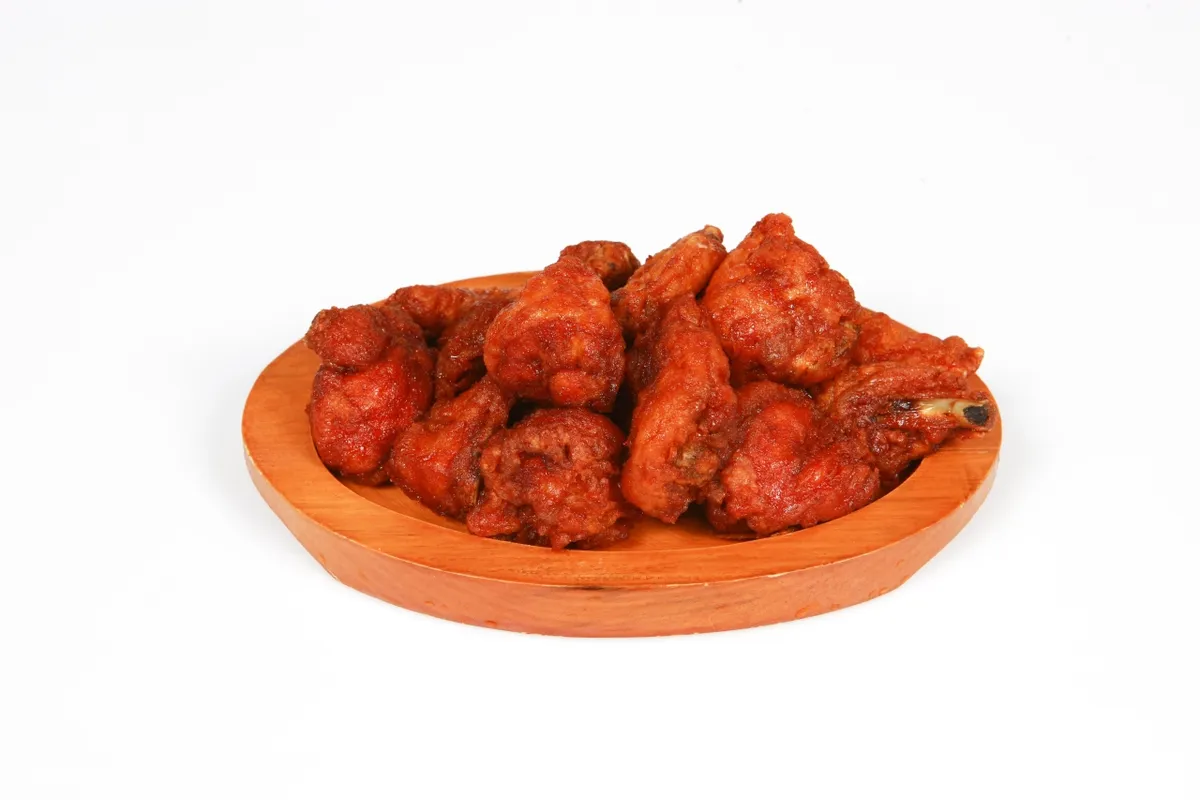 Red yangnyeom chicken served on a plate for a Korean fried chicken guide