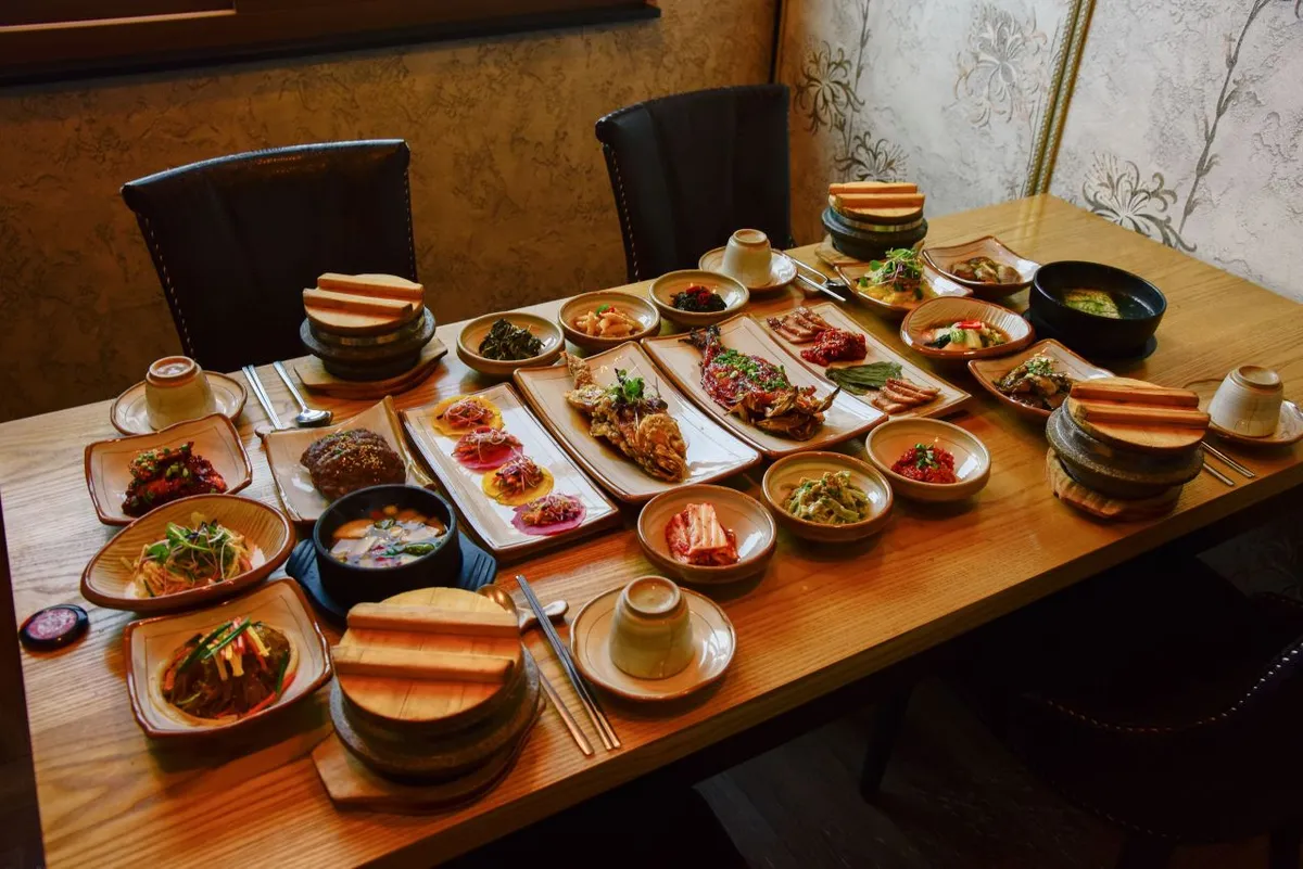 Korean rice set meal with stone-pot rice main dishes soup and side dishes