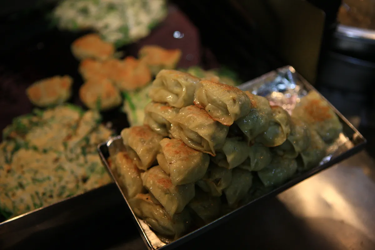 Fried dumplings and twigim snacks in a Korean street food display
